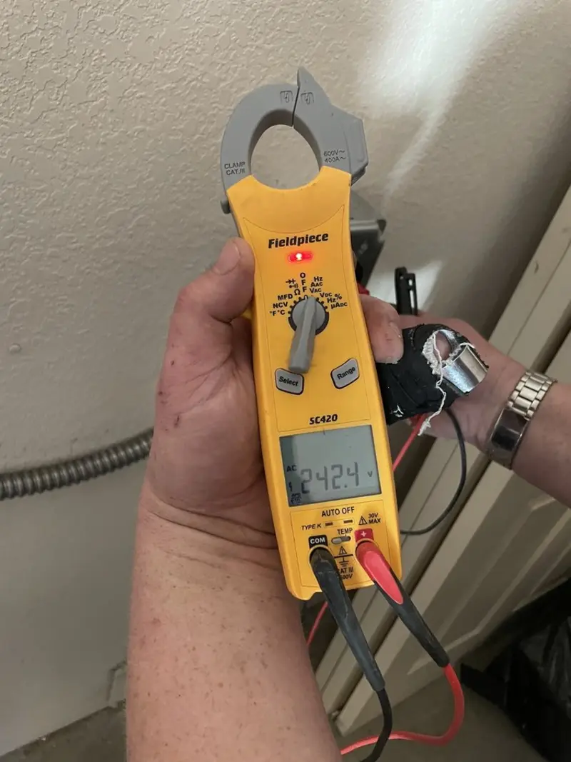 Voltage testing with clamp meter during Electrical Installation Services in Hernando